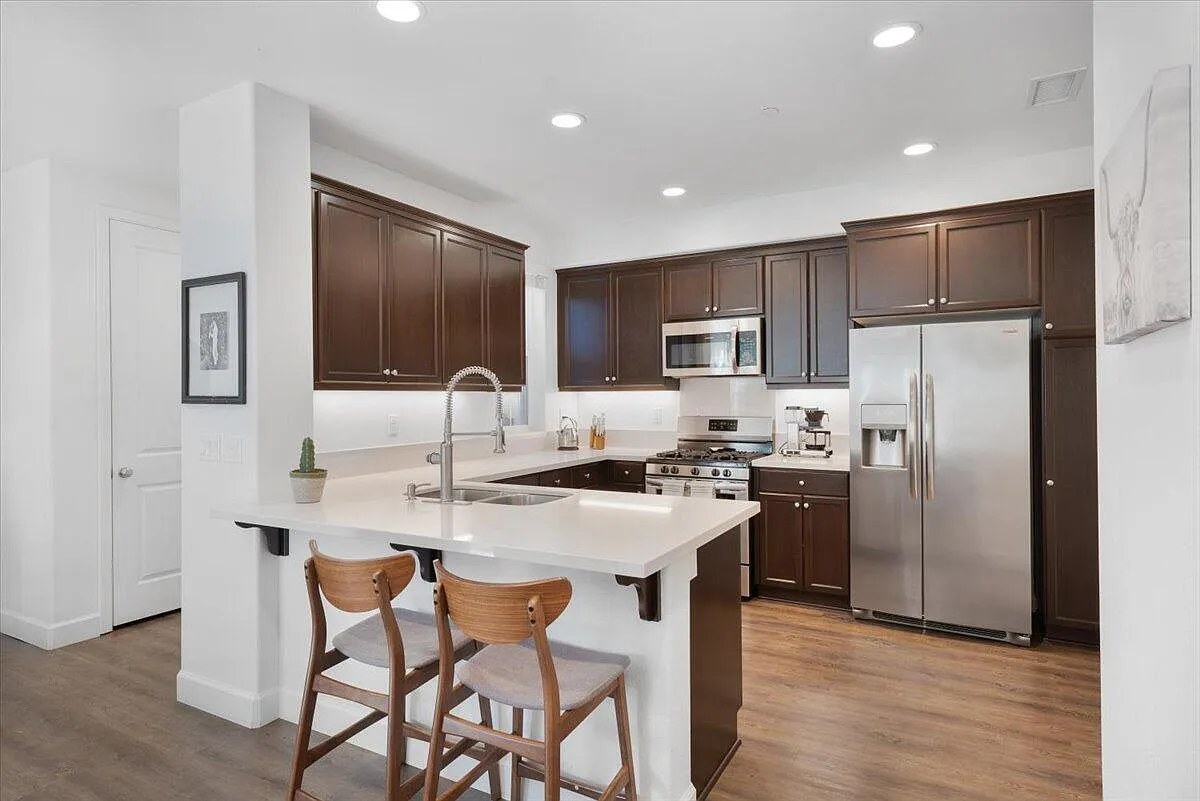 Sold condo kitchen Buellton CA Santa Ynez Valley — dark wood cabinets quartz island — Ursula Santana Realtor BHHS CA DRE #01965452